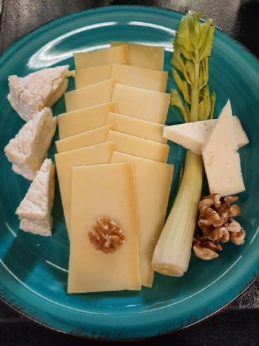 a plate of cheese and nuts on a blue plate at Hotel Schlossberg in Badenweiler