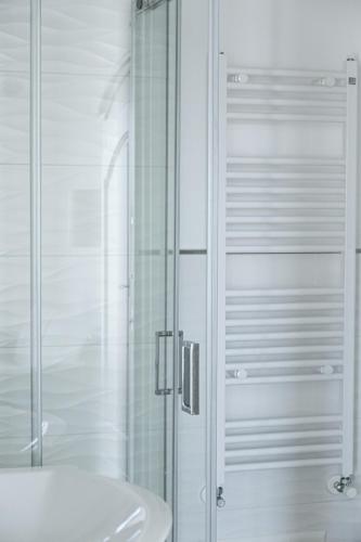 a bathroom with a glass shower and a sink at Casa Clementina Rooms vista mare in Porto Cesareo