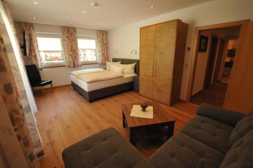 a living room with a bed and a couch at Haus Passler in Sankt Jakob in Defereggen