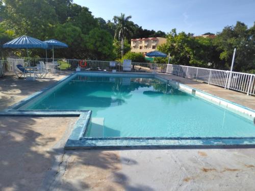 een zwembad met blauw water in een tuin bij Irresistible View-Mobay Club 1408 in Montego Bay