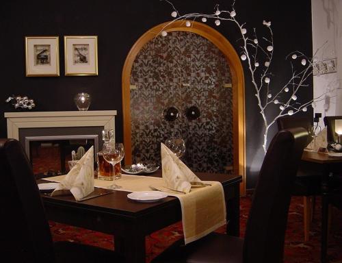 a dining room with a table and a mirror at Hotel Palatino in Sundern