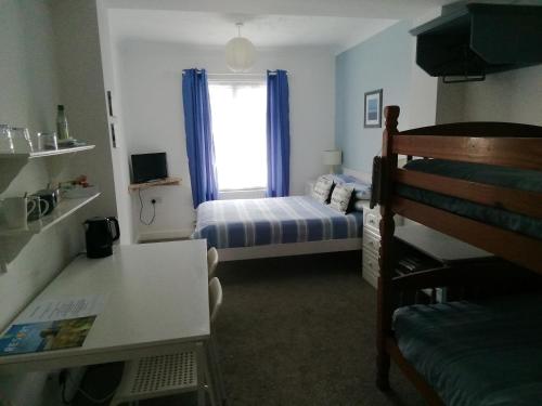 a small room with a bed and a window at Railway Cottage in Swanage