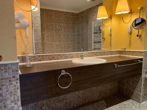 a bathroom with a sink and a large mirror at Barcelo Royal Beach Private Apartment in Sunny Beach