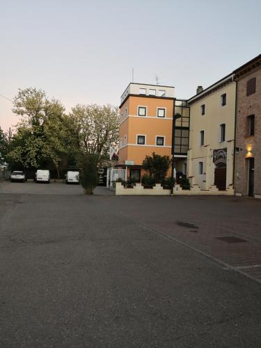 an empty parking lot in front of a building at Hotel La Cantina in Alfonsine