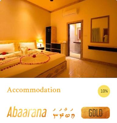 a hotel room with a bed and a door to a kitchen at Veli Beach Inn in Mathiveri