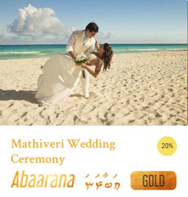 a bride and groom standing on the beach at Veli Beach Inn in Mathiveri