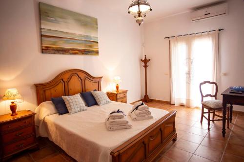 a bedroom with a bed with two towels on it at Finca Pou Monjo in Caimari