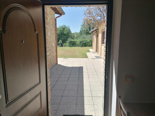 an open door with a view of a yard at BorgoPratole CountryHouse in Cingoli