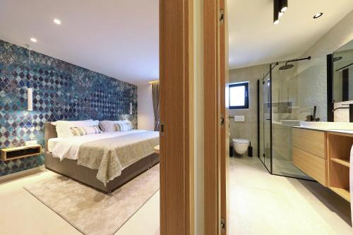 a bedroom with a bed and a bathroom at Luxury Aparthotel Zadar in Zadar