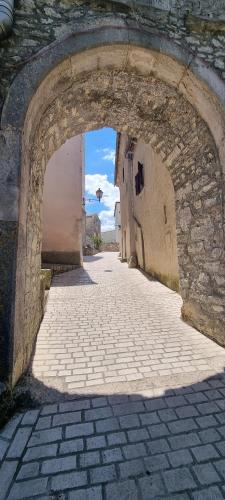 a stone alley with an archway in a building at Salvia in Pićan