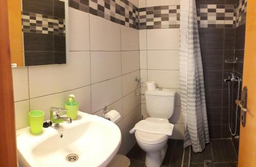 a bathroom with a sink and a toilet and a shower at Sea&Park View in Skala Marion