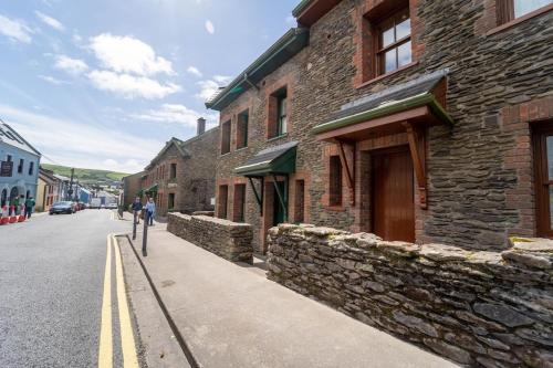 a stone building on the side of a street at Burnham View in Dingle
