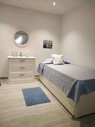 a bedroom with a bed and a dresser with a mirror at Bayview in Pembroke 