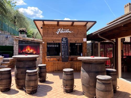 a bar with barrels in front of a building at Albergo Casa Este in Brenzone sul Garda