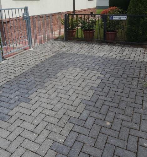 a brick patio with a gate and a fence at URS Ferienwohnung Wertheim in Wertheim