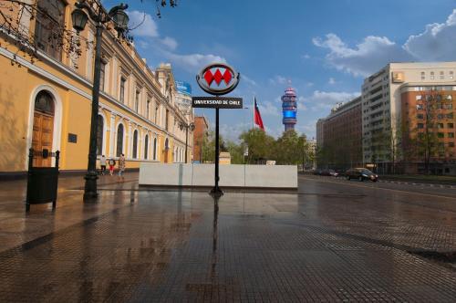 a street sign on the side of a city street at Hotel Plaza San Francisco in Santiago