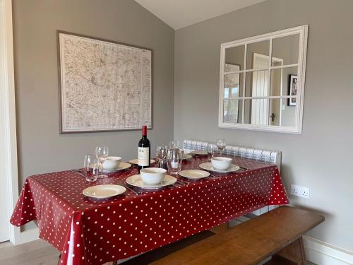 a table with a red and white polka dot table cloth at Glebe Barn, Little Glebe Farm in Cheltenham