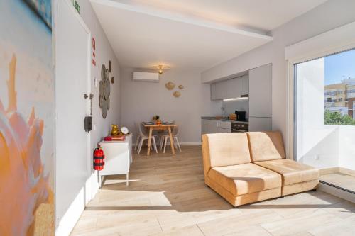 a living room with a couch and a table at Natural Grey Albufeira in Albufeira