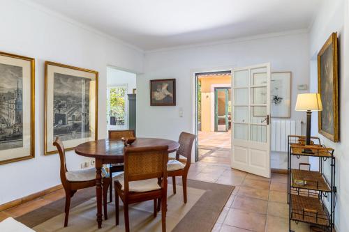 a dining room with a table and chairs at Finca Son Blat in Porto Cristo