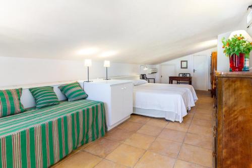 a bedroom with a bed and a couch in a room at Finca Son Blat in Porto Cristo