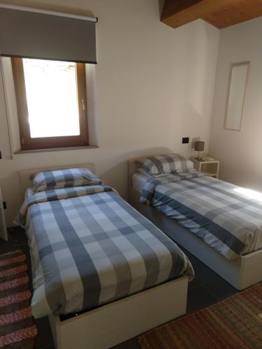 a bedroom with two beds and a window at appartamento salino in San Ginesio