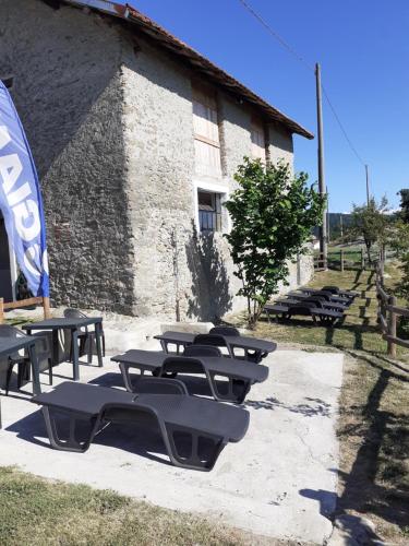 a group of picnic tables in front of a building at Cascina Merlo Country House in Pareto