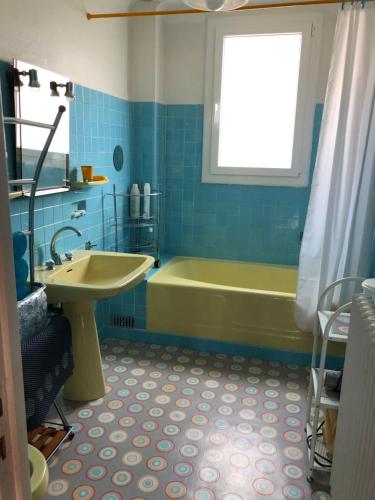 een badkamer met een groen bad en een wastafel bij Montcalm in Millau