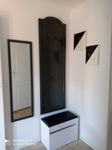 a bathroom with a mirror and a white dresser at Apartament Pod Wiśnią in Supraśl