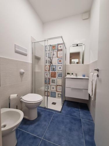 a bathroom with a toilet and a sink at Le petite Maison in San Vito lo Capo