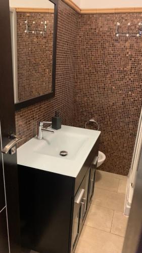 a bathroom with a sink and a mirror at Apartment Parque Royale 1 in Adeje