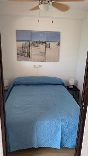 a bed in a bedroom with a picture of the beach at Apartment Parque Royale 1 in Adeje