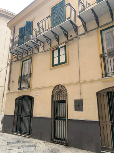 a building with bars on the front of it at Cartari Apartment in Palermo