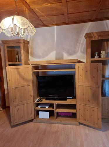 a large entertainment center with a flat screen tv at Ela Vital Ferienwohnung in St. Blasien