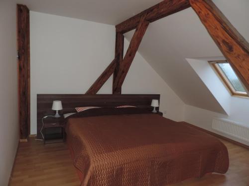a bedroom with a brown bed in a attic at Chateau Diva in Turčianske Teplice