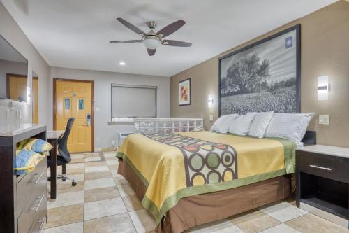 a hotel room with a bed and a desk at Texas Inn Donna in Donna