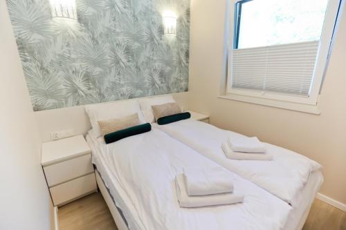 Ένα ή περισσότερα κρεβάτια σε δωμάτιο στο M&K Apartament Nadmorski Zagajnik - Sobieszewo, Wyspa Sobieszewska