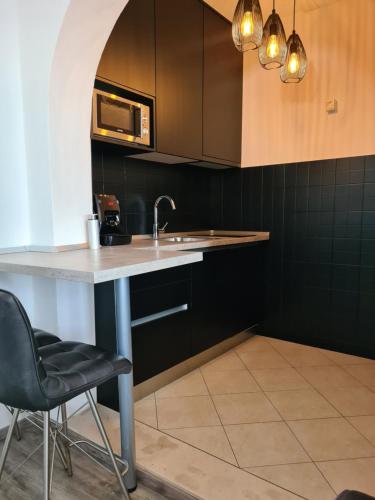 a kitchen with a sink and a microwave at Bed and Breakfast Villa Klaic in Dubrovnik