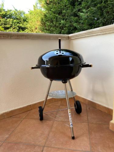 a black grill sitting on top of a patio at Villa Teresa in Ginosa Marina