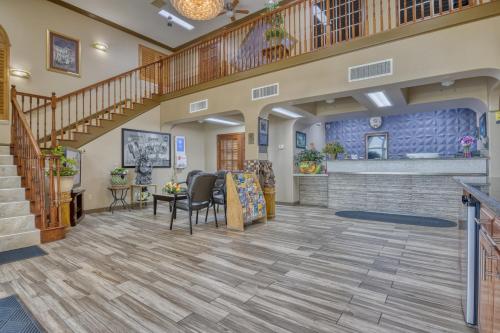 a lobby with a staircase and a living room at Texas Inn Donna in Donna