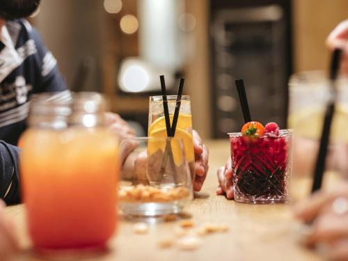 a group of people sitting at a table with drinks at Aparthotel Adagio London Sutton Point in Sutton