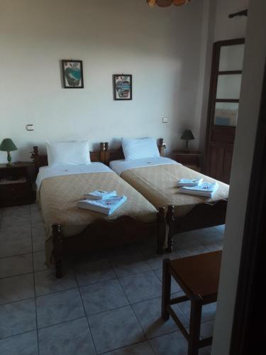 a bedroom with two beds with towels on them at Magda Studios - Double Bed Room N4 in Zagora
