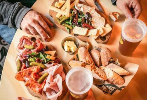 a table topped with different types of sandwiches and drinks at Aparthotel Adagio London Sutton Point in Sutton