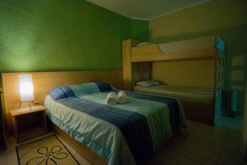 a bedroom with two bunk beds with shoes on the bed at Hotel Estação Paraíso - ao lado do Metrô Paraíso e 600m da Av Paulista in Sao Paulo
