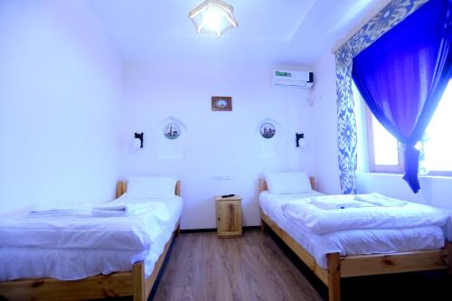 Vuode tai vuoteita majoituspaikassa Shahriston - Hotel Khiva