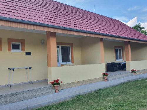 a small yellow house with a red roof at Ubytovanie LISKA in Radava