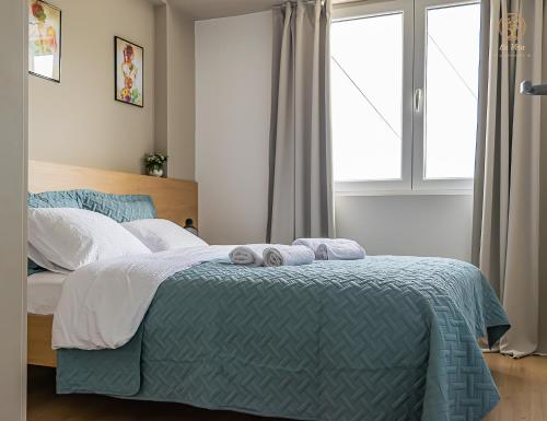 a bedroom with a bed with two towels on it at La Vita Apartment 2 in Ohrid