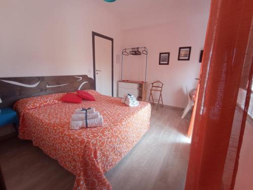 a bedroom with a bed with red pillows on it at Idria B&B in Barcellona-Pozzo di Gotto