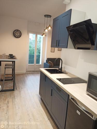 a kitchen with a sink and a counter top at Joli Appartement avec balcon clim in Graulhet