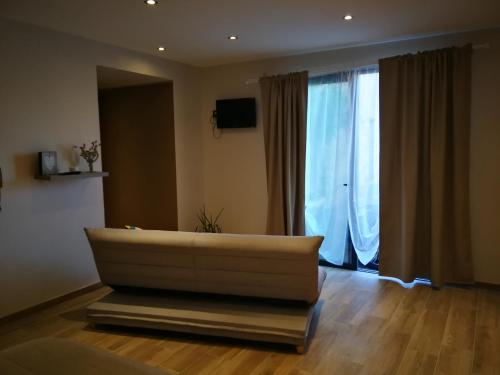 a living room with a couch and a large window at Terre des marais in Marchésieux