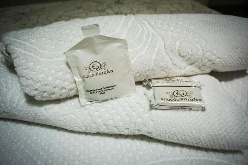 a bottle of soap sitting on top of a towel at Hotel Estação Paraíso - ao lado do Metrô Paraíso e 600m da Av Paulista in Sao Paulo